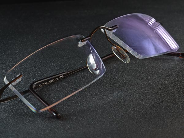Pair of eye glasses with an anti-reflective coating showing the reflex-color blue